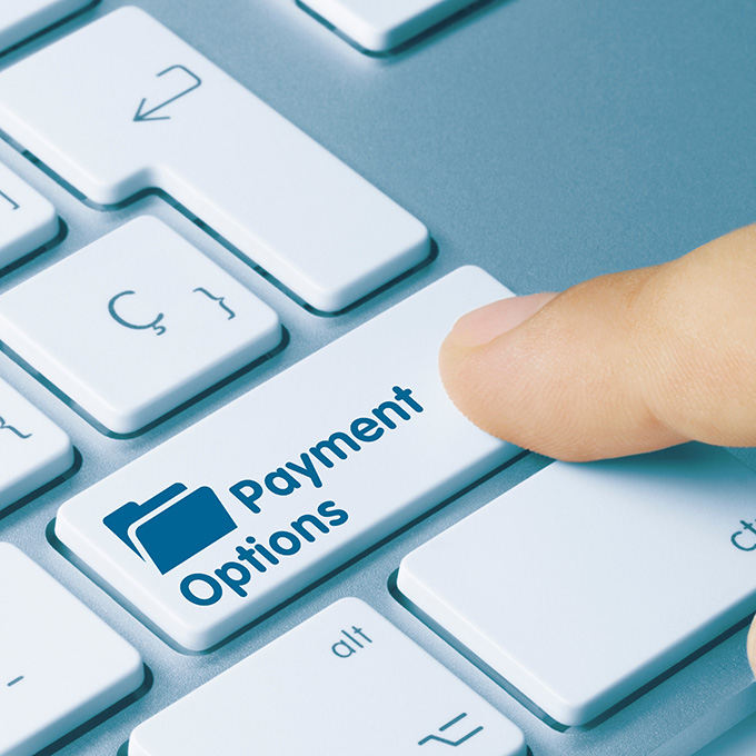 Person pressing Payment Options on their laptop keyboard Person pressing Payment Options on their laptop keyboard